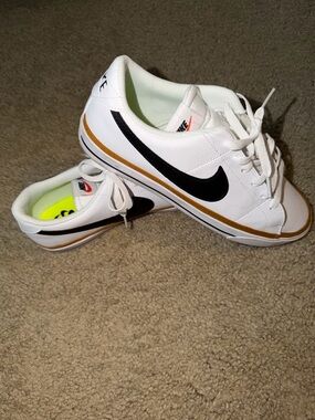 Nike White Sneakers with Black Swoosh and Gold Stripe